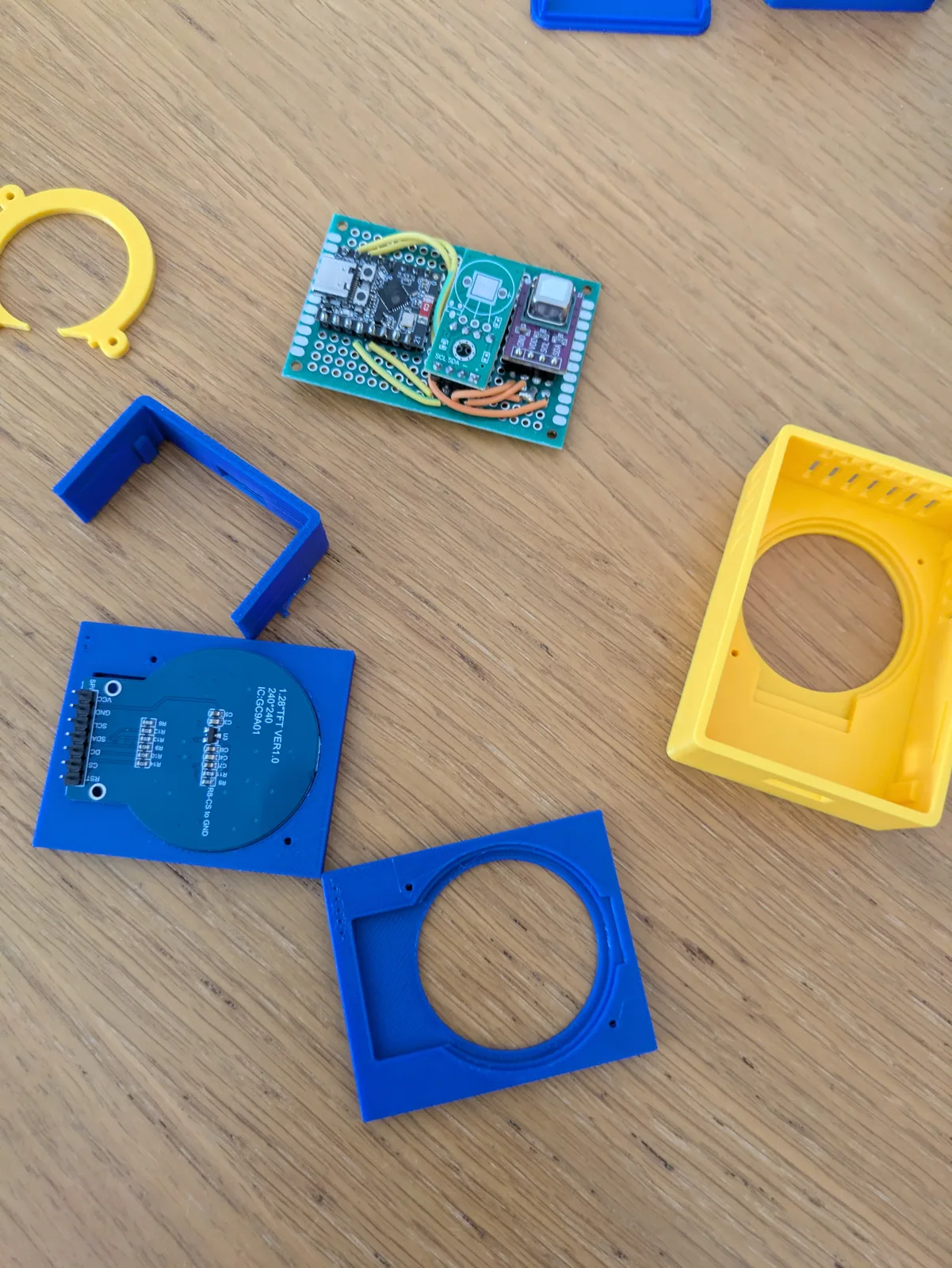 Blue and yellow enclosure iterations with the display and perfboard