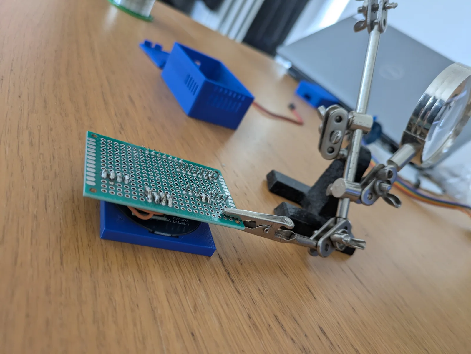 Soldering the perfboard connections.