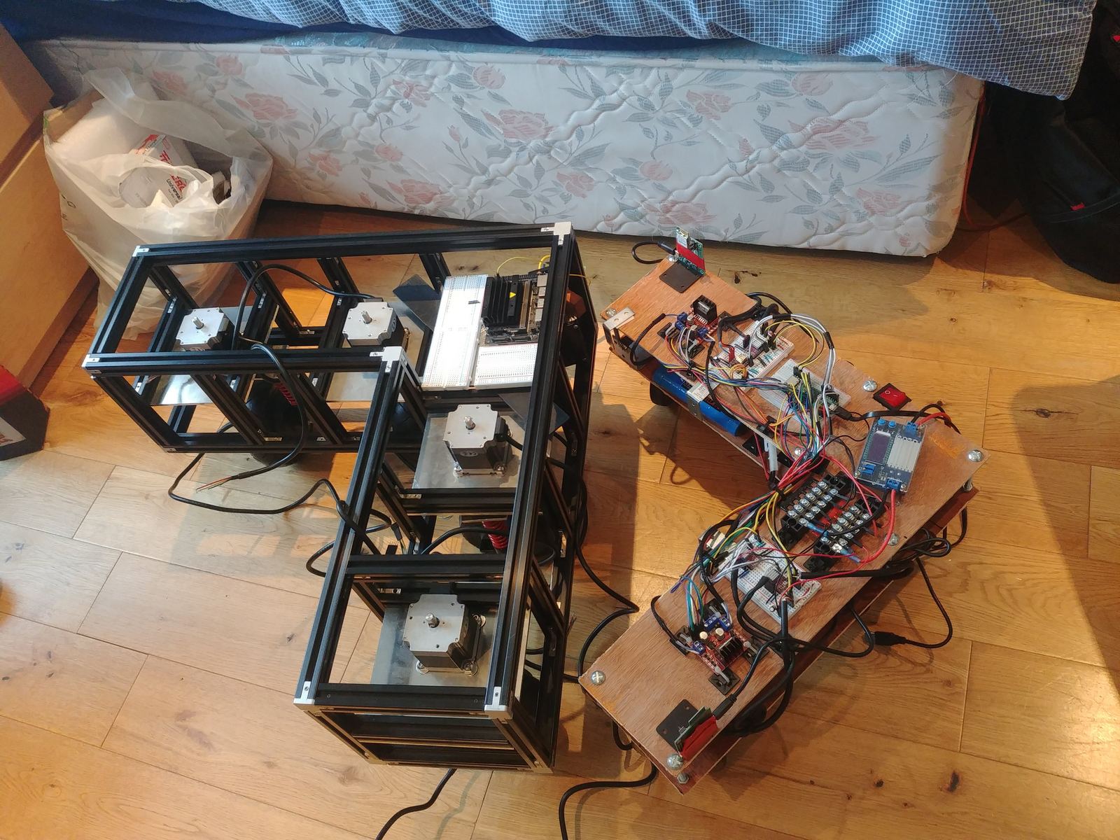 The first and second robot prototypes side by side on the floor