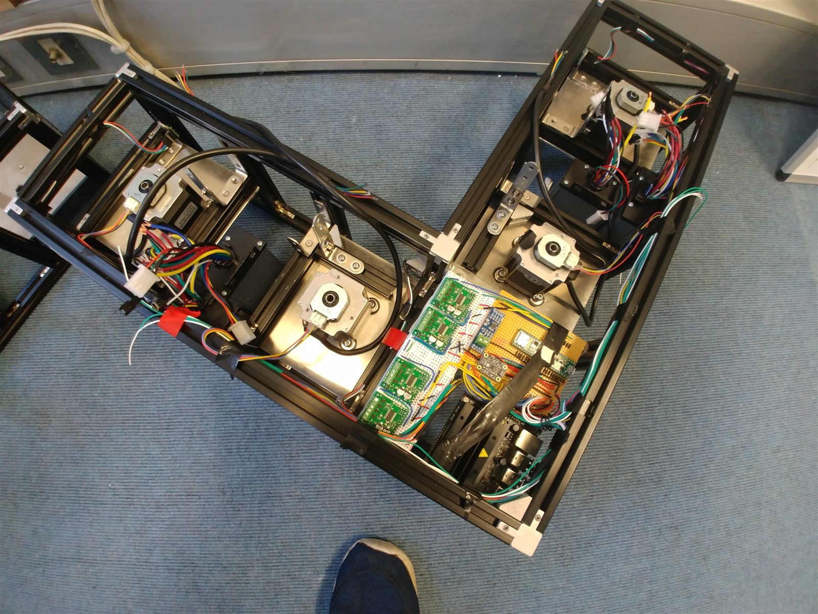Three autonomous robot prototypes with exposed electronics
